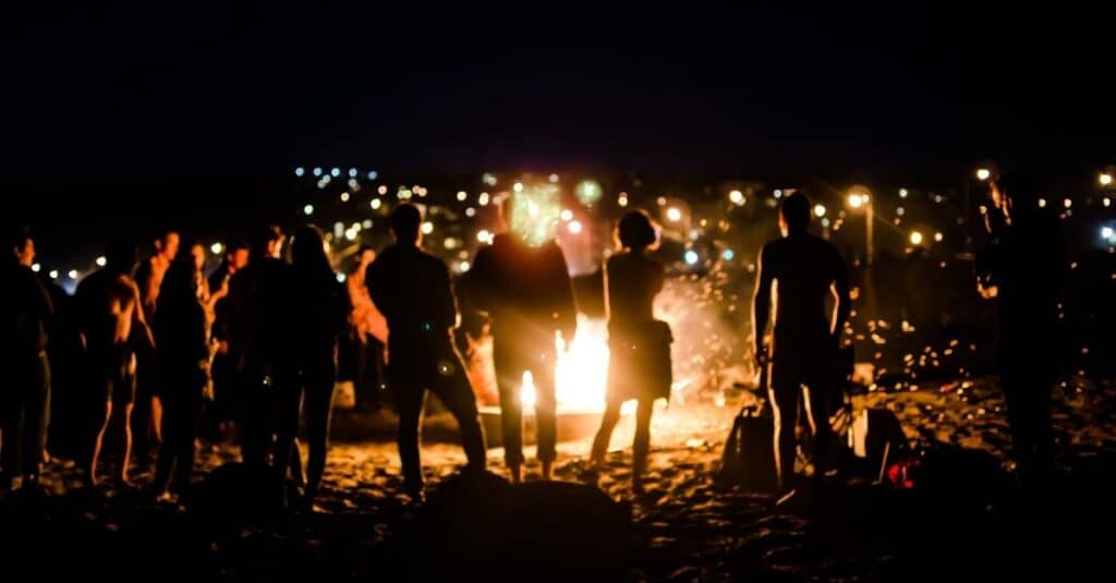 picture of a bonfire party on the beach at night