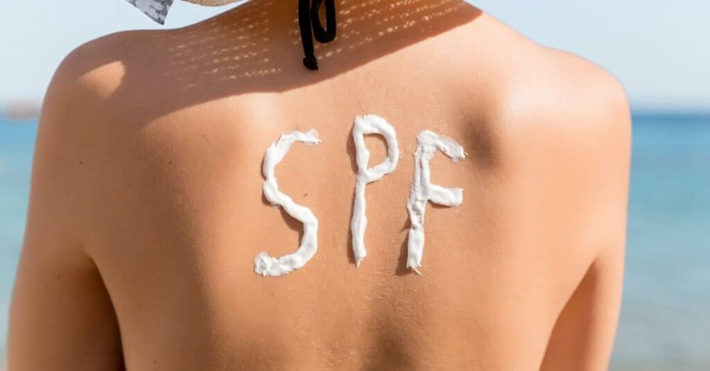 picture of sunblock on a woman's back